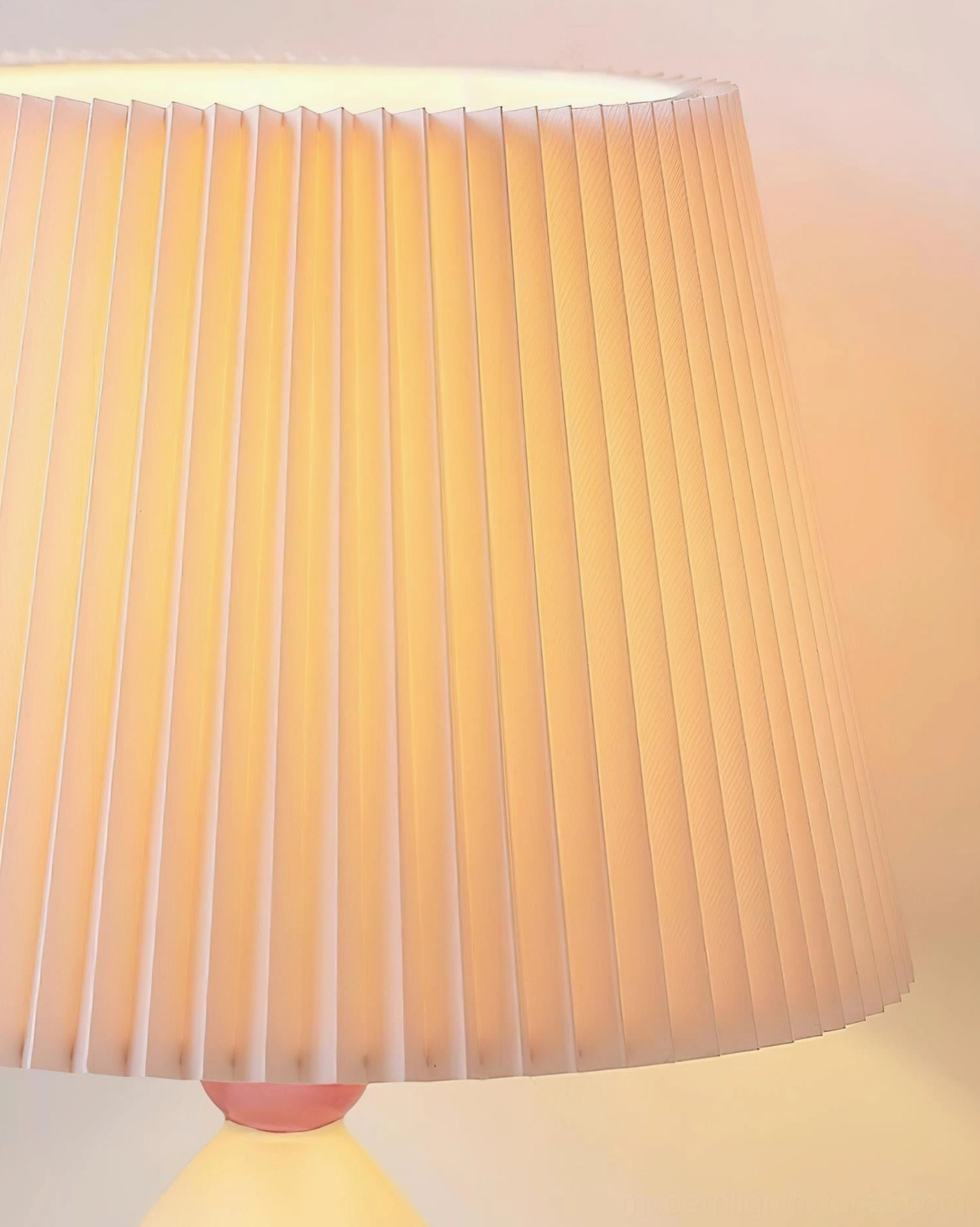 Luma Globe pleated fabric lampshade close-up detail showing vertical pleats and warm light transmission through fabric