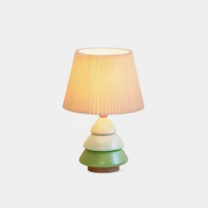 Luma Globe modern table lamp front view with pleated shade and gradient green to ivory tiered resin base on white background