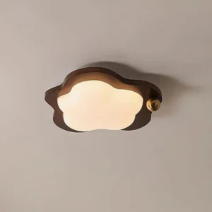 Modern cloud-shaped ceiling light fixture mounted overhead with frosted acrylic diffuser glowing softly