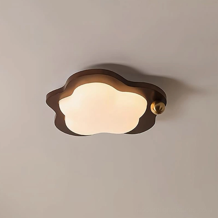 Modern cloud-shaped ceiling light fixture mounted overhead with frosted acrylic diffuser glowing softly