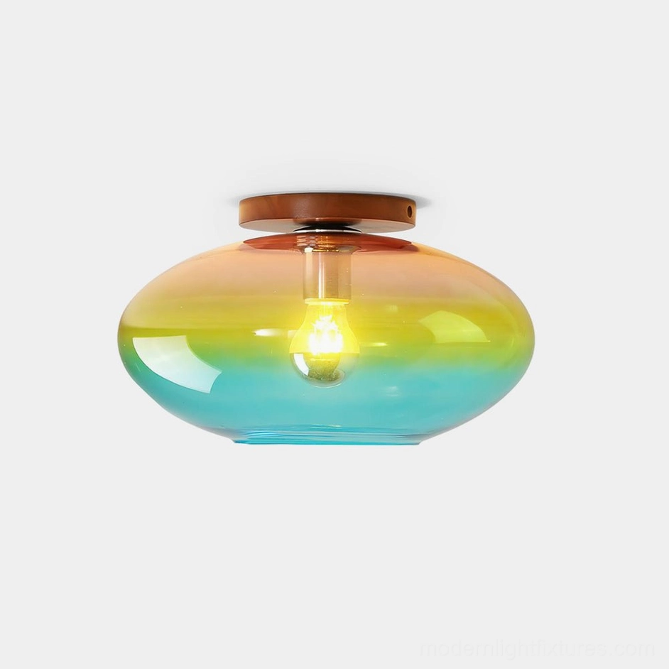 Lumia ombré ceiling light front view with gradient glass shade transitioning from pink to amber to turquoise and walnut wood canopy on white background