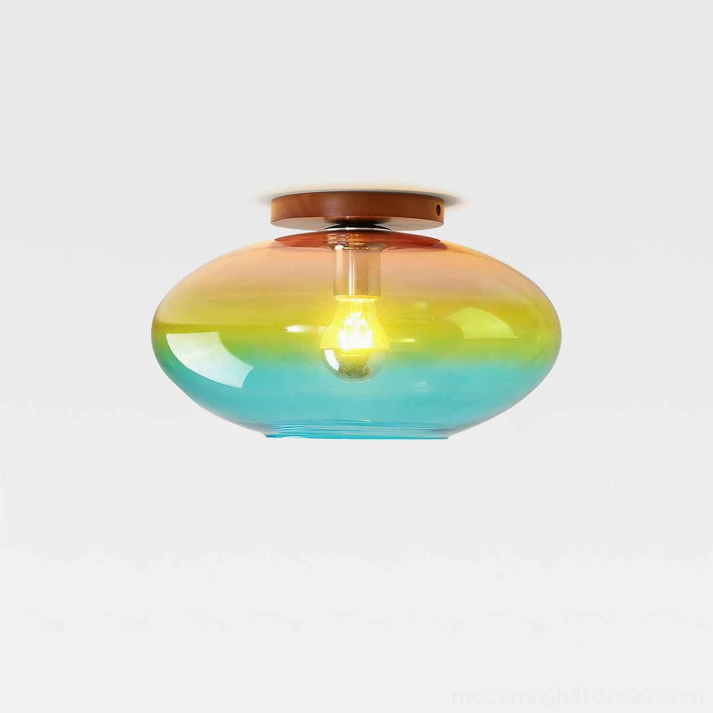 Lumia gradient ceiling light close-up front view with illuminated exposed bulb and smooth ombré glass finish in multicolor clear glass