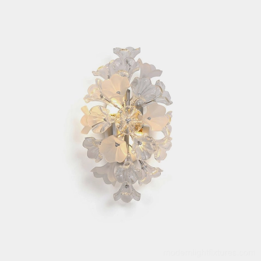 Lumiflora crystal glass wall sconce with frosted petals and polished metal frame on white studio background