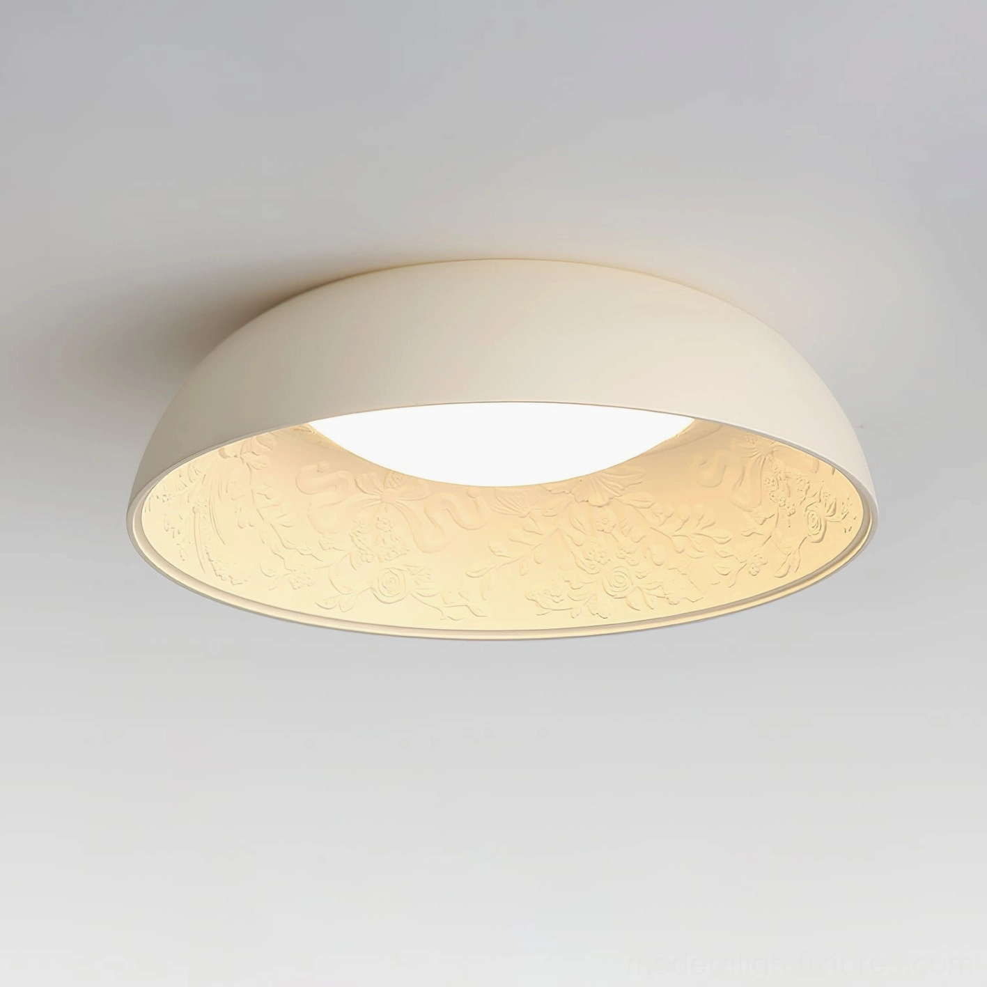 Close-up detail of Lumina ceiling light showing embossed inner surface with floral pattern and warm white glow