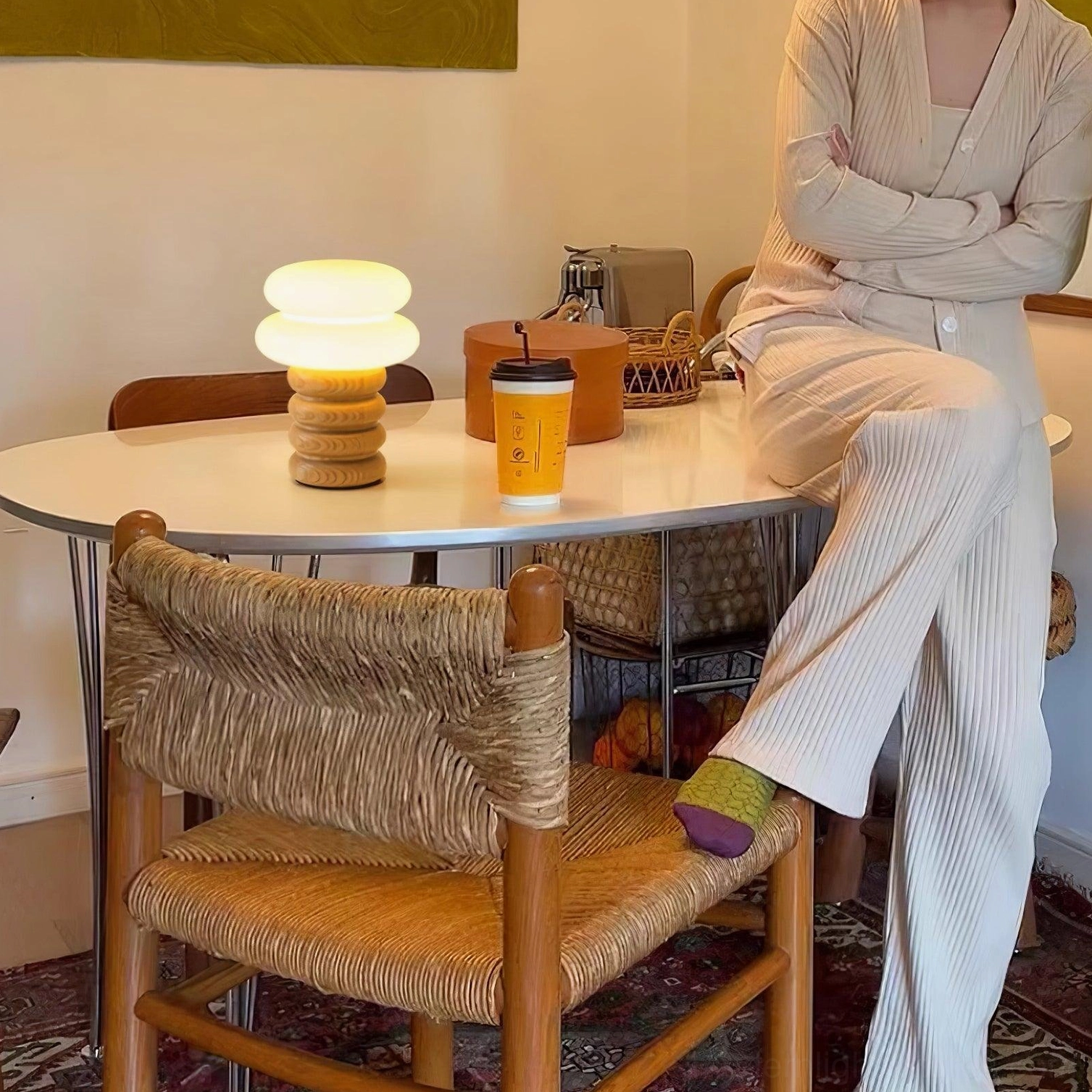 Modern stacked wood table lamp illuminated creating soft diffused light atmosphere