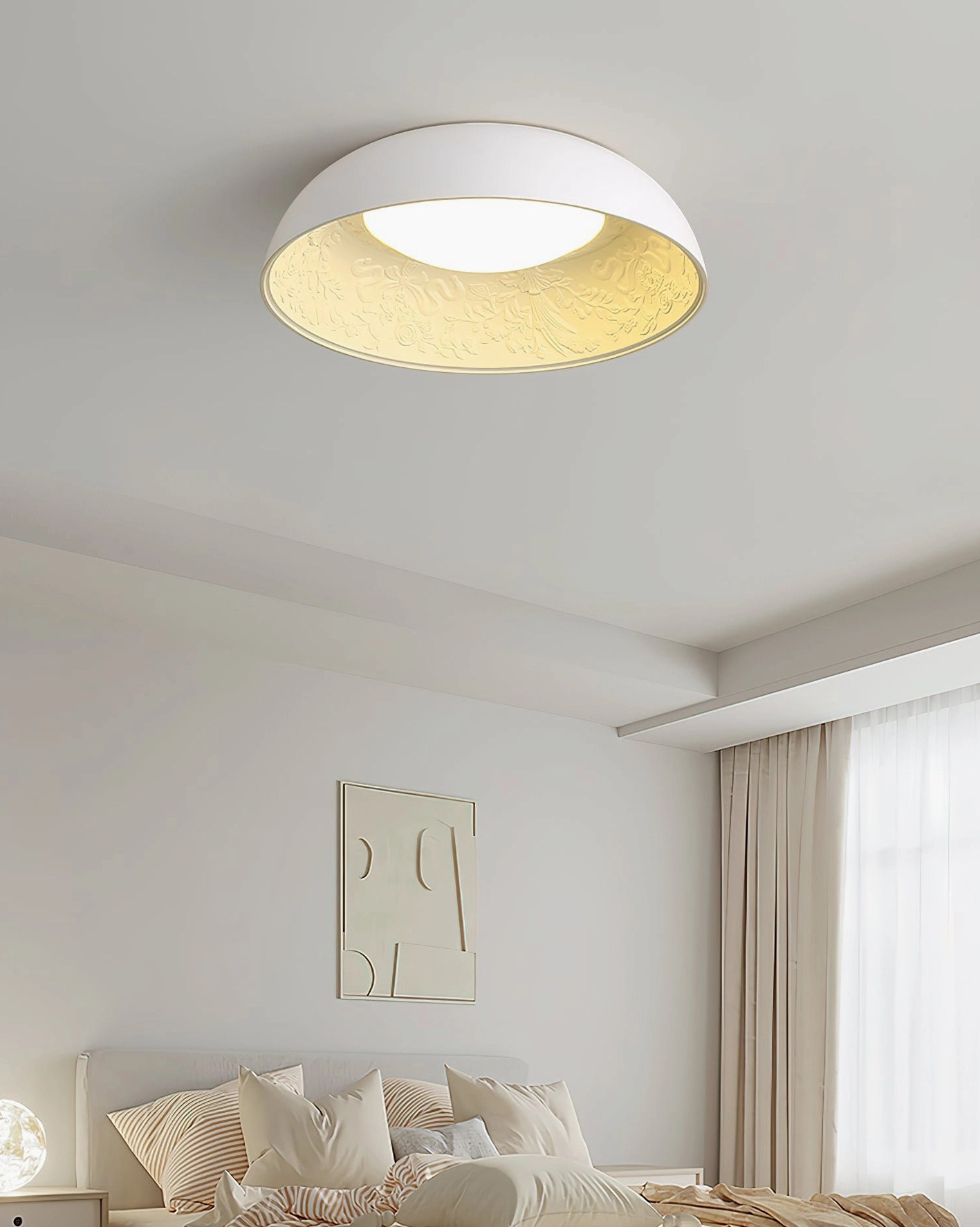 Lumina cream ceiling light creating warm ambient glow in modern bedroom with wall art and soft lighting