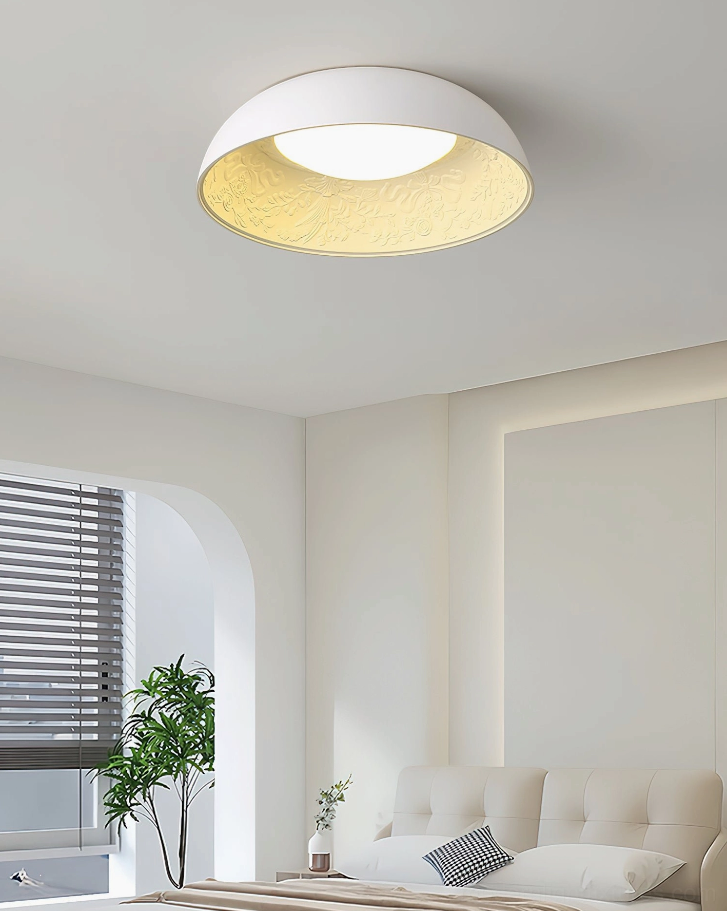Lumina flush mount ceiling light in minimalist all-white bedroom with potted plant and modern decor