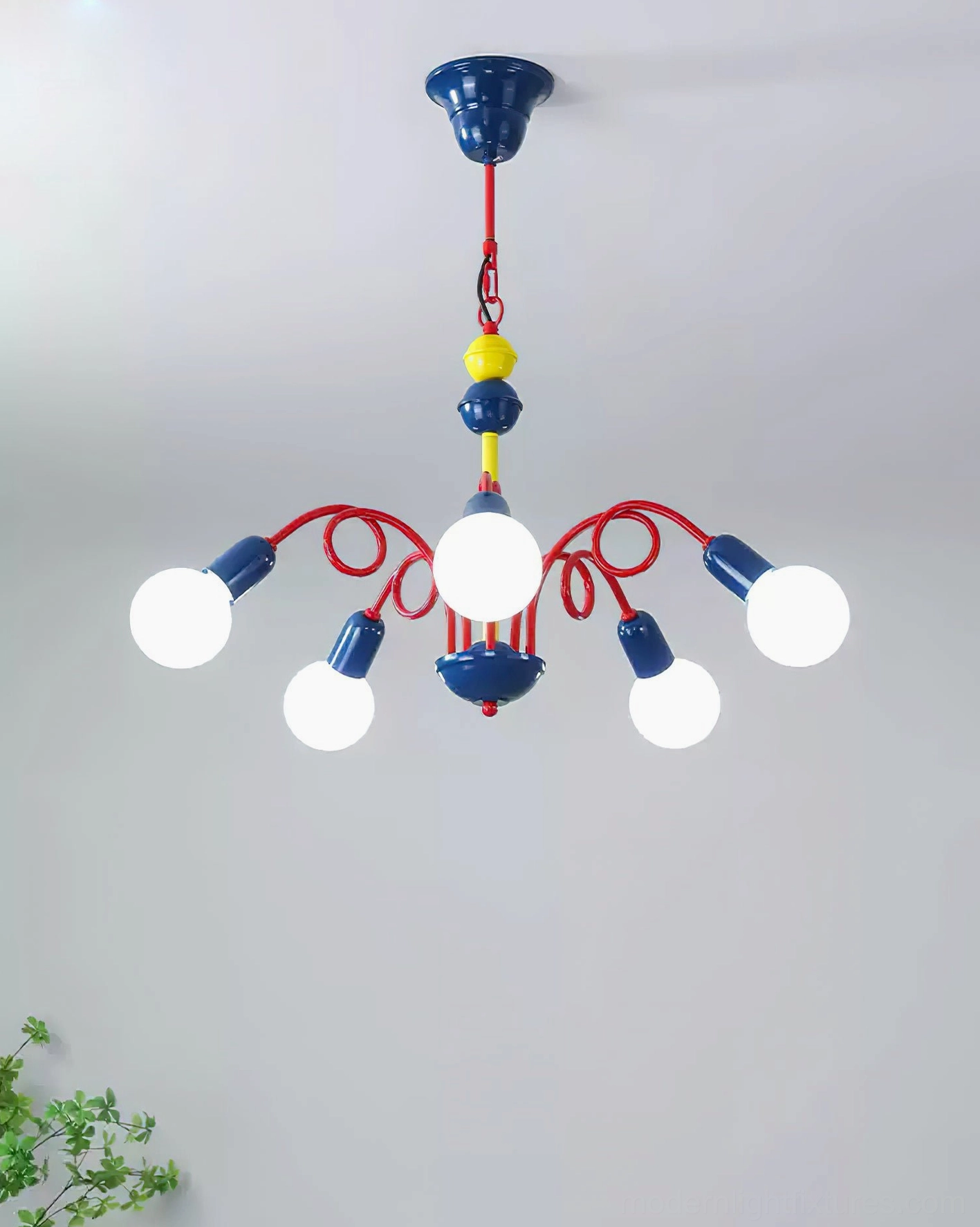 Luminosa 4-light compact chandelier in contemporary home setting with green plant decor