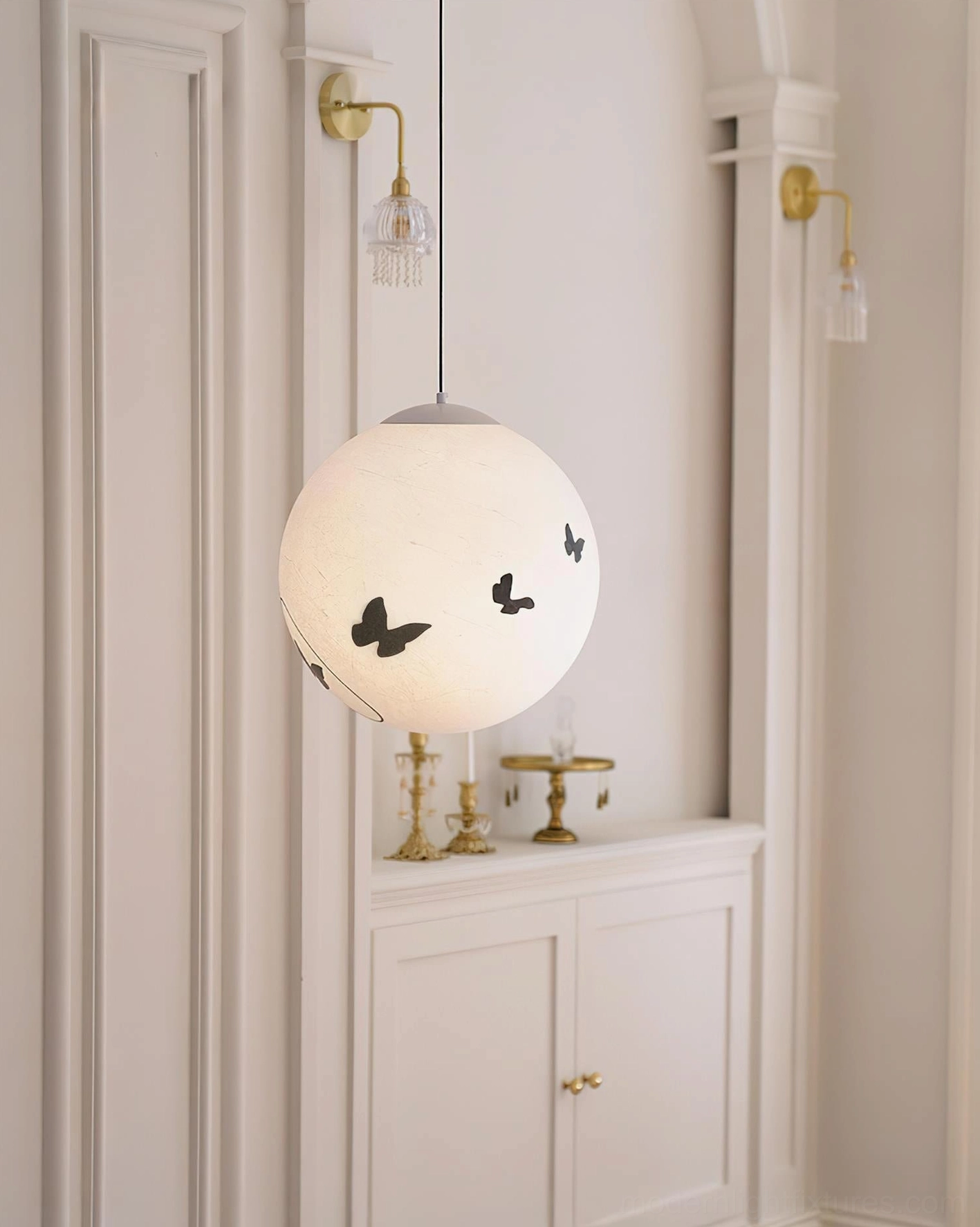 Luna Flutter modern pendant light in indoor hallway with decorative wall panels, butterfly shadow patterns