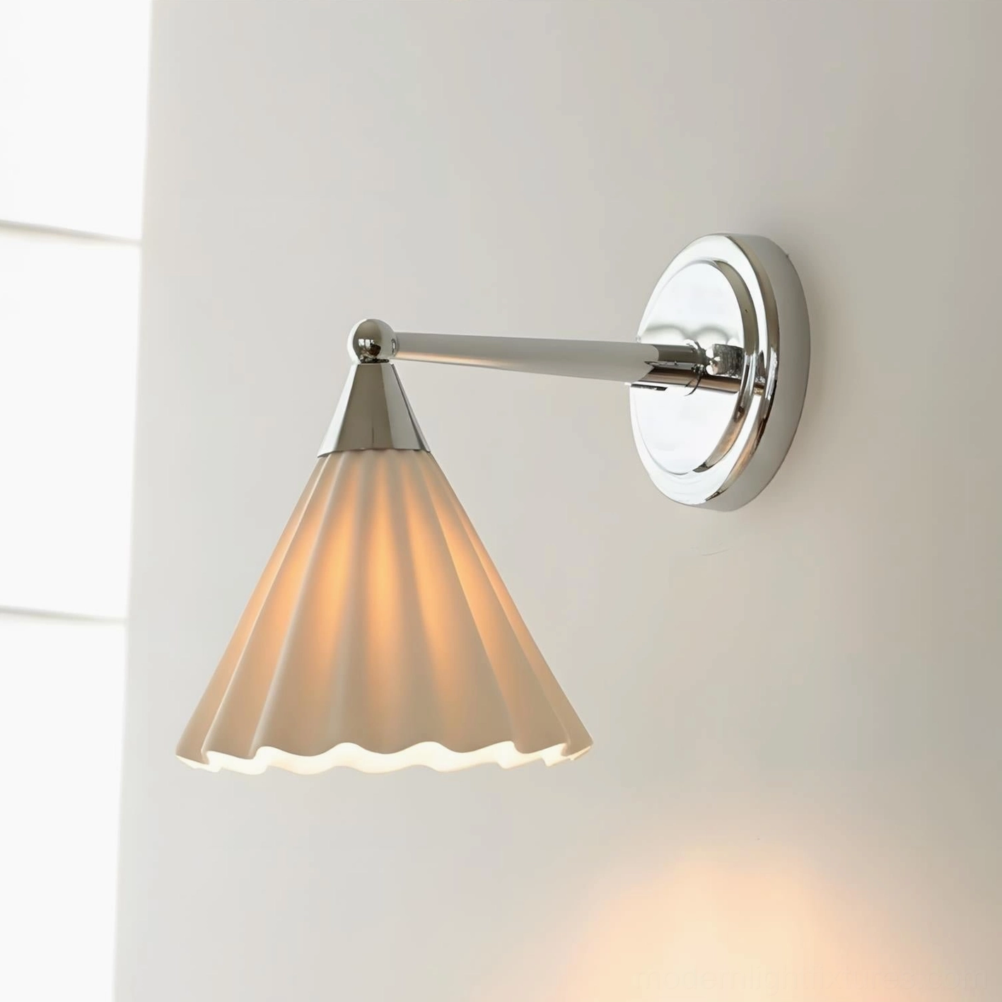Luna Scallop wall sconce close-up product shot showing illuminated warm light and polished chrome details