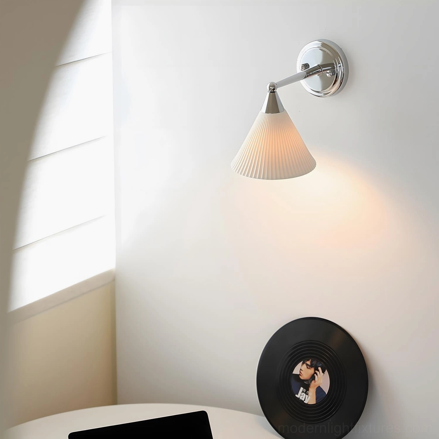Single Luna Scallop wall lamp mounted in corner of small apartment nook, ceramic pleated design detail