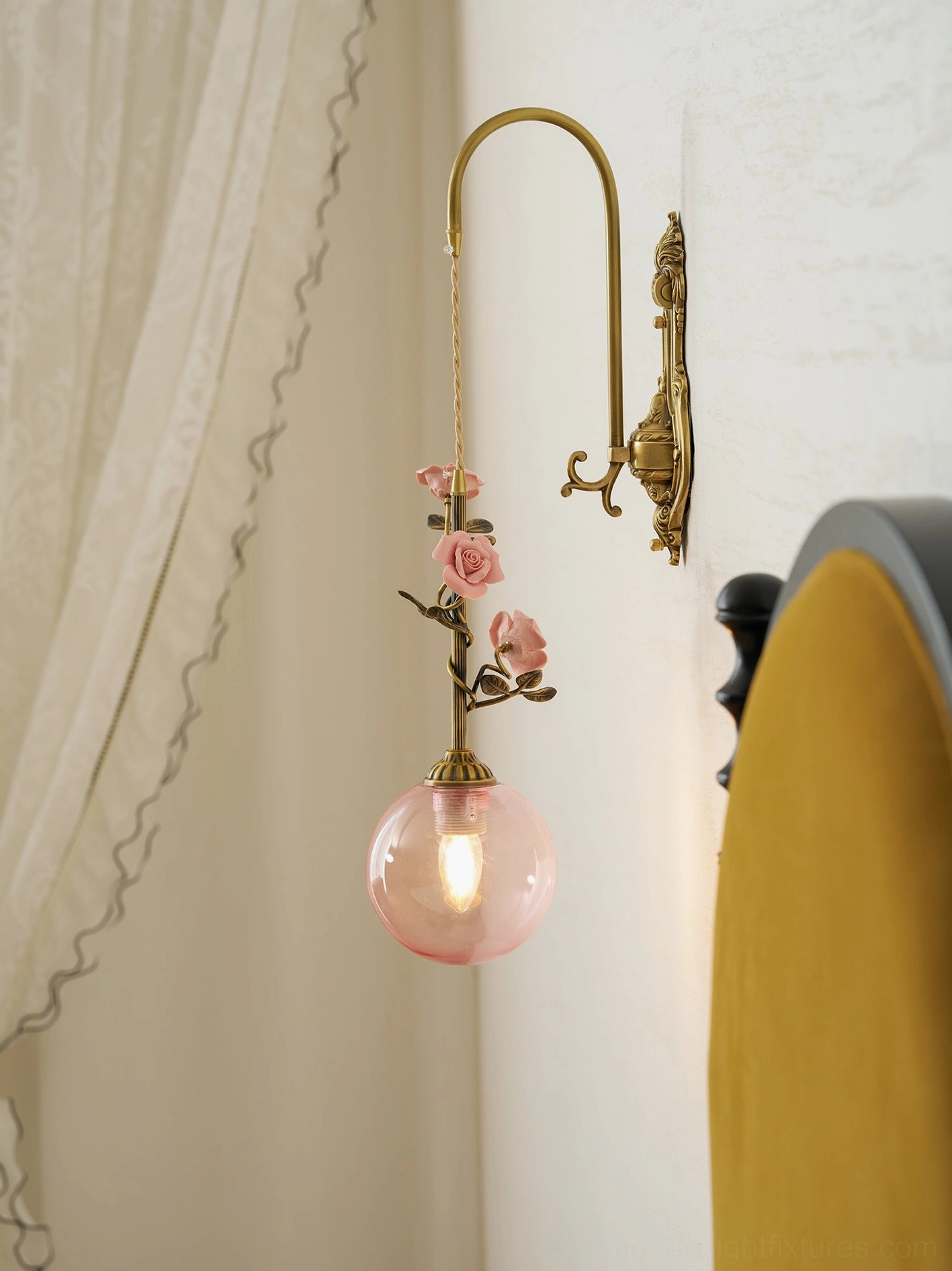 Lunafleur porcelain rose wall sconce illuminating gallery wall with artwork and accents