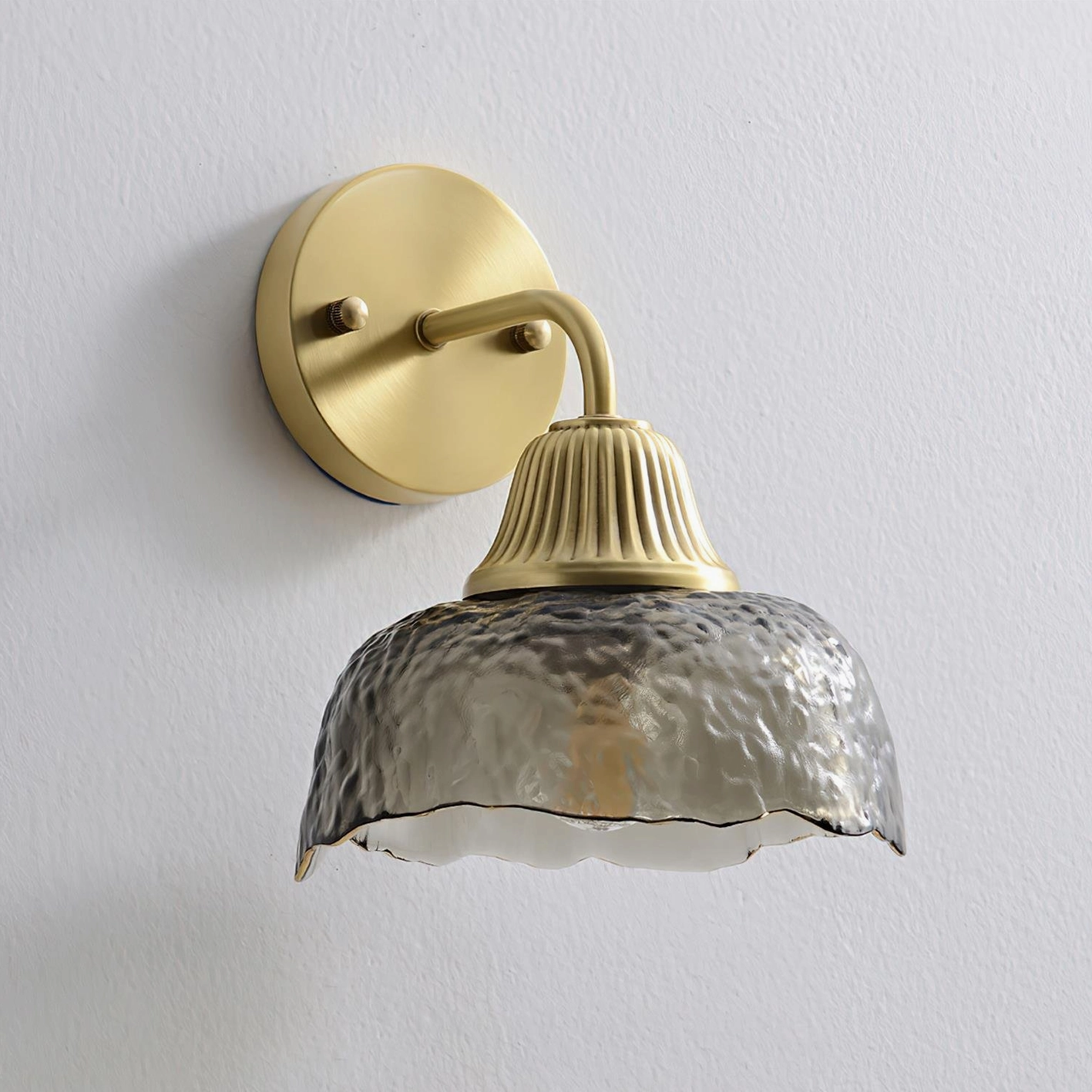 Lunara modern wall sconce brushed brass fixture with ribbed metal neck and fluted detailing, side angle