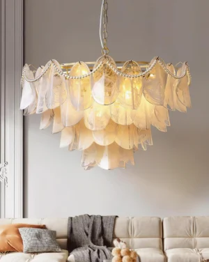 Tiered petal glass chandelier low angle upward view in modern luxury living room with French neoclassical interior design and beige neutral décor