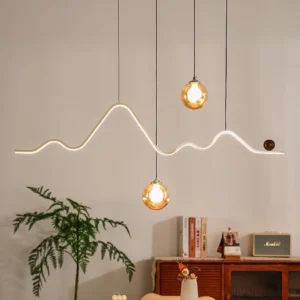 Warm-lit Lunaris pendant light in contemporary home setting with cabinet and potted plant ambiance