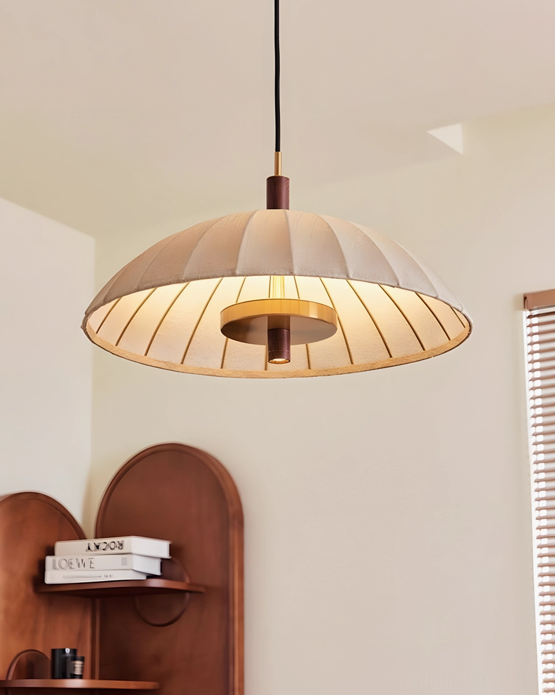 Lunaro illuminated pendant lamp showing glowing pleated fabric shade and warm light diffusion in home corner