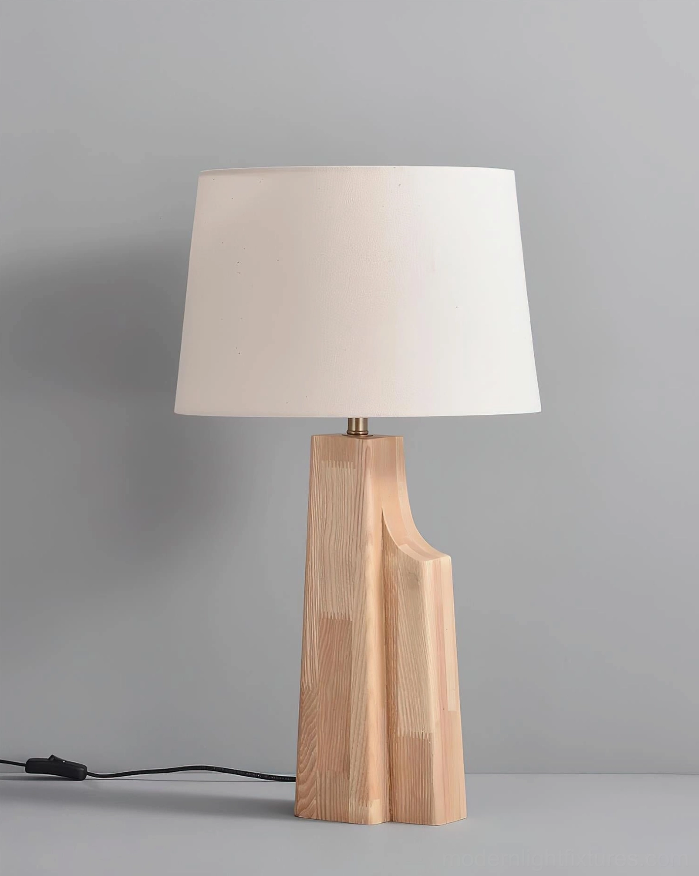 Lunet table lamp powered on displaying warm ambient illumination through soft fabric shade