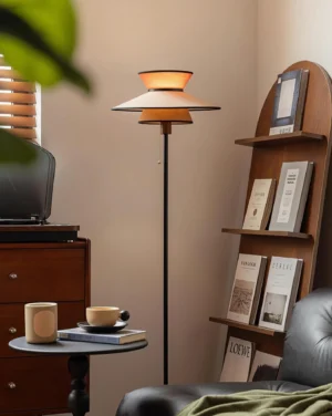 Lunetra floor lamp in vintage living room setting with leather sofa, providing warm ambient lighting in retro home decor