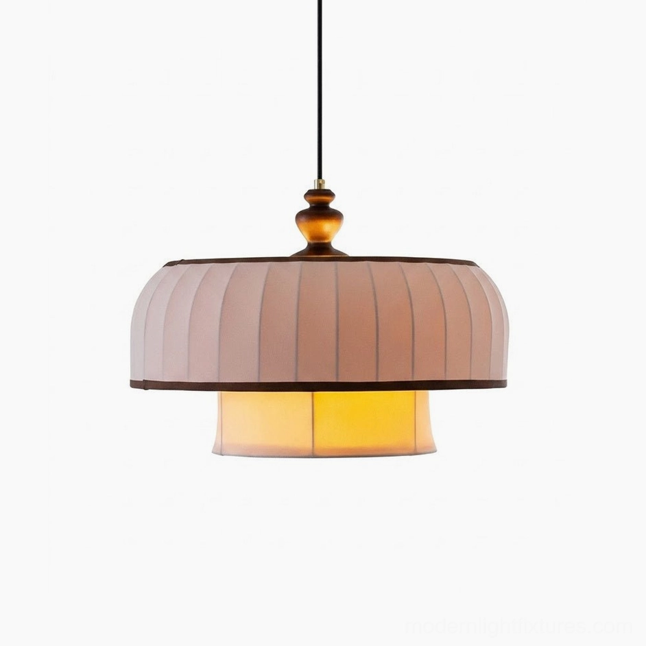 Lunette pendant light full product shot on plain background, showcasing two-tier pleated fabric shade, dark walnut piping trim, turned wood finial, and warm interior lighting
