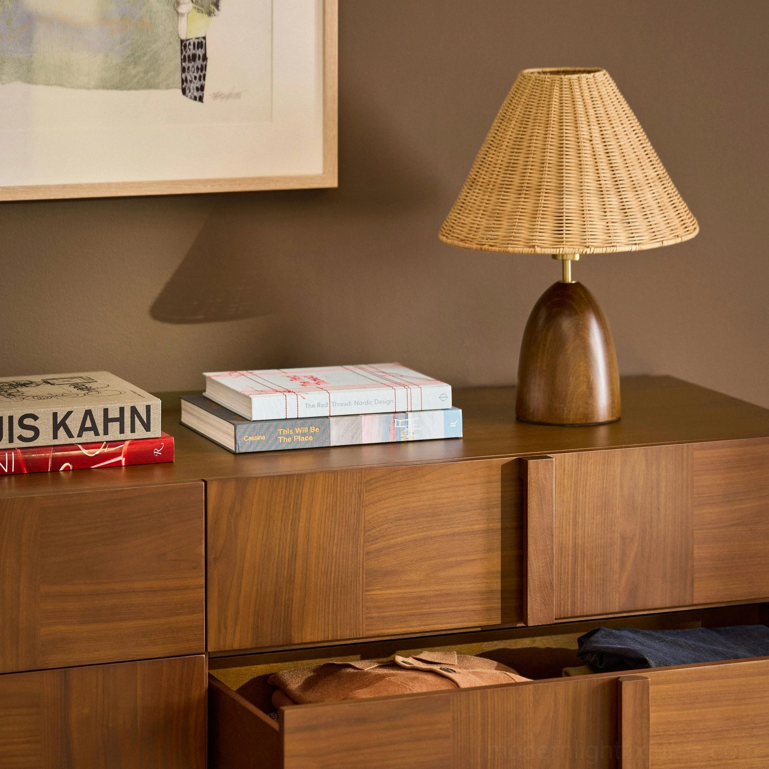 Lunora table lamp on living room sideboard styled with books, framed art and open storage