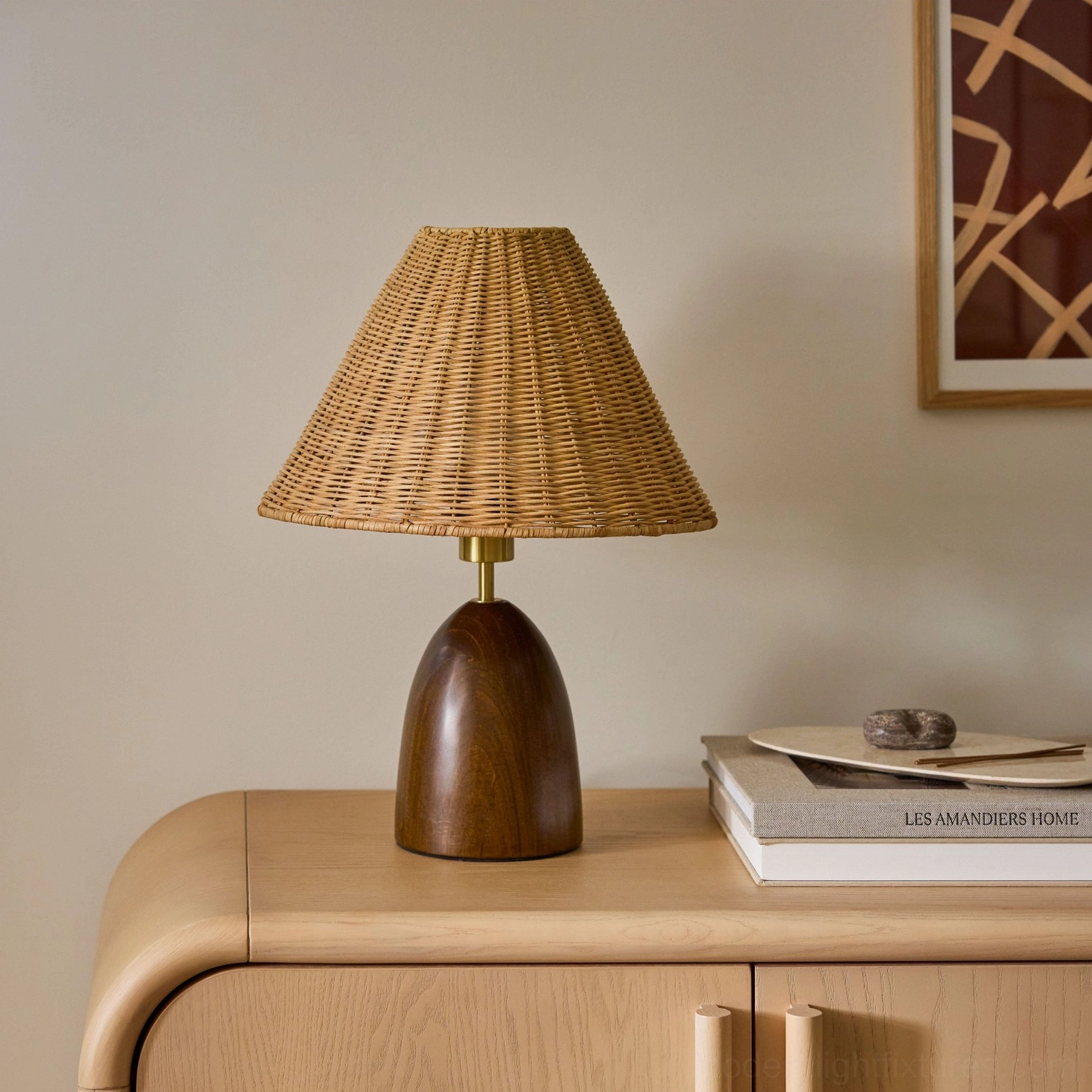 Lunora accent lamp displayed on side cabinet with stacked books and decorative stone objects
