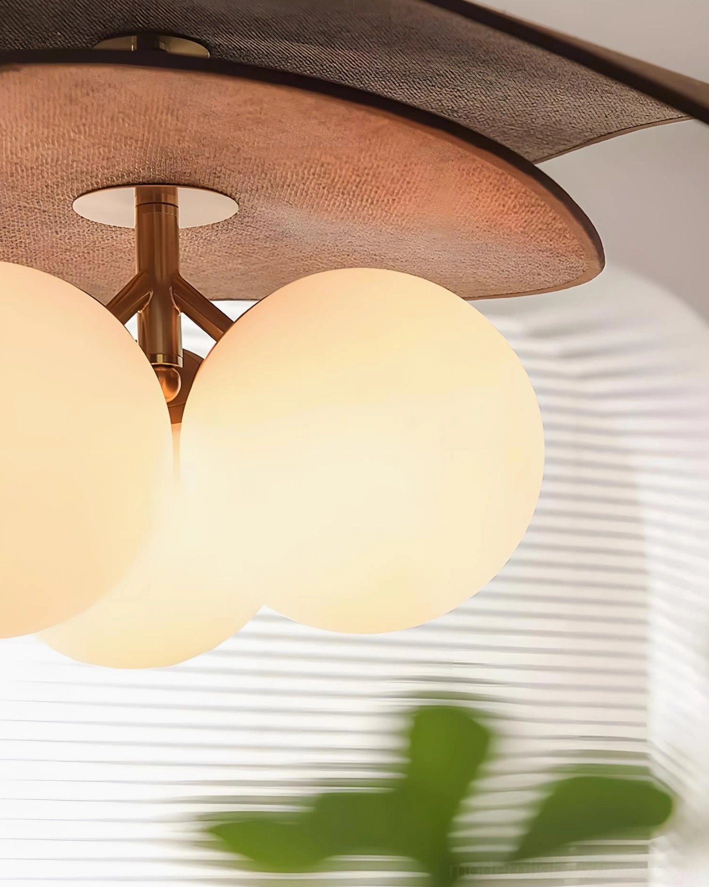 Lunova pendant light showing brushed metal accents and warm wood frame in refined interior setting
