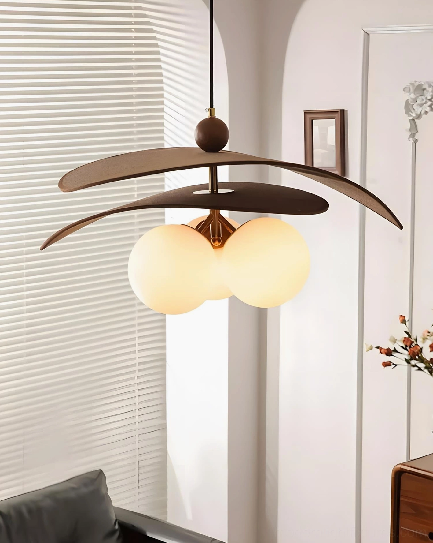 Lunova modern pendant light creating focal point in Scandinavian-inspired dining room with warm wood furniture