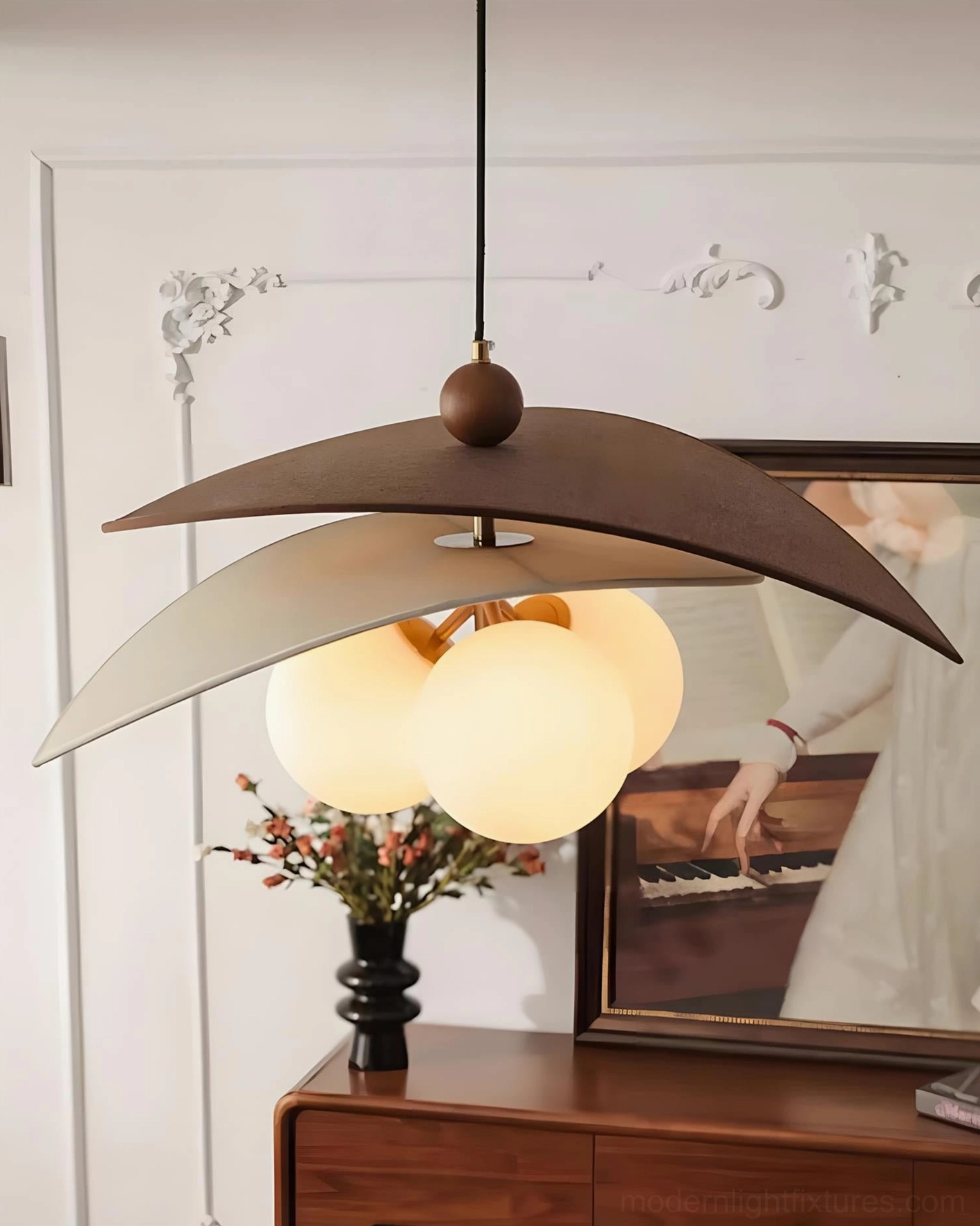 Side profile view of Lunova sculptural disc pendant light showing layered crescent panels and natural raffia texture