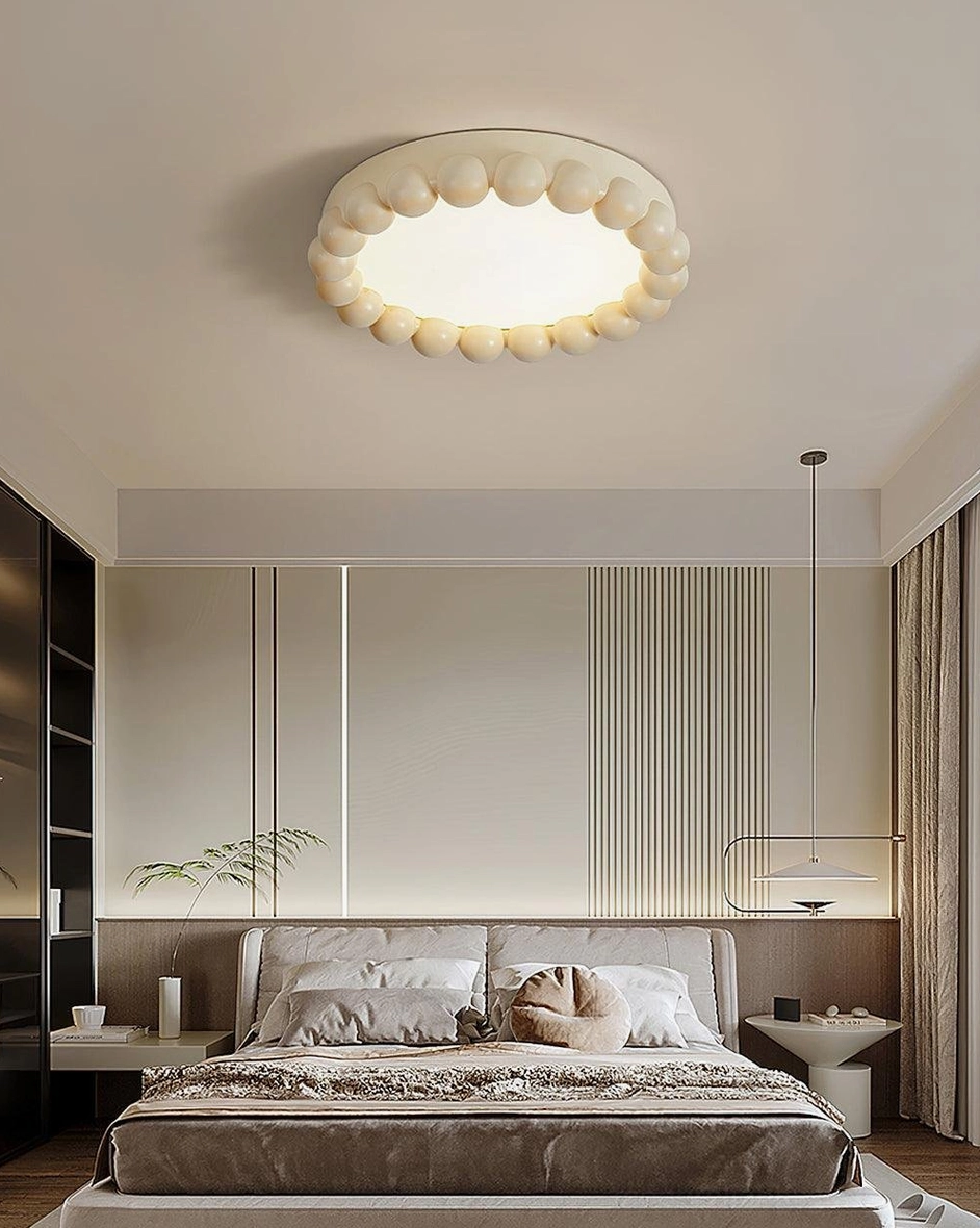 Beaded ceiling light fixture mounted in light luxury bedroom creating soft diffused illumination