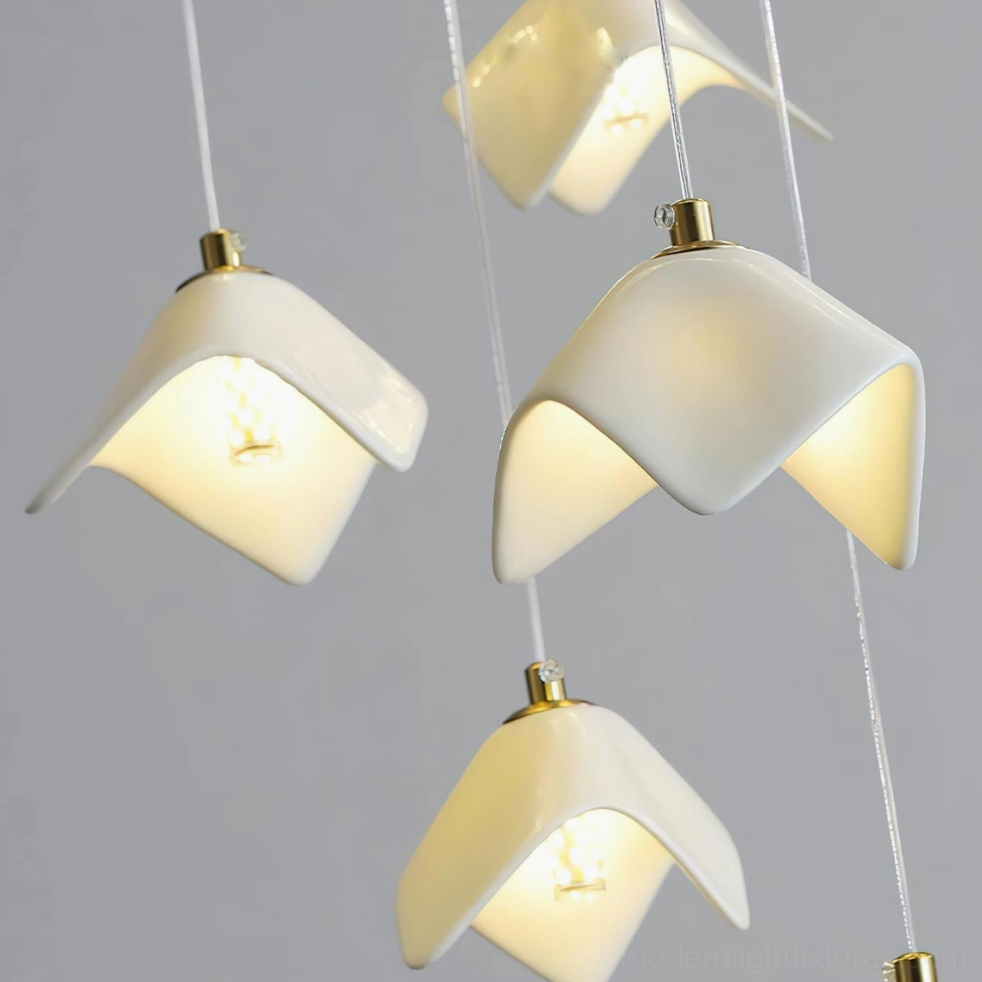 Cascading bloom chandelier in modern hotel lobby creating luxury ambiance with layered light diffusion