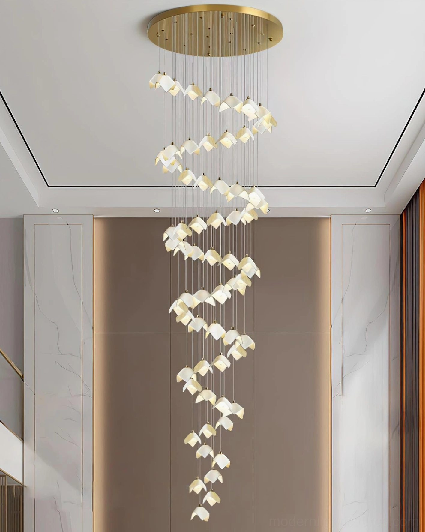 Modern cascading bloom chandelier installed in luxury residential foyer with high ceiling and polished finishes