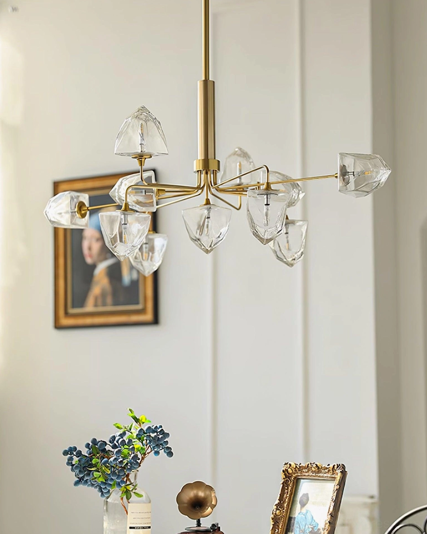 Luxury brass gold contemporary chandelier with clear glass shades and gold suspension rod in elegant home