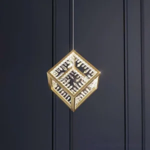 Gold Kristy pendant lamp close-up showing carved translucent panel details and gold metal frame