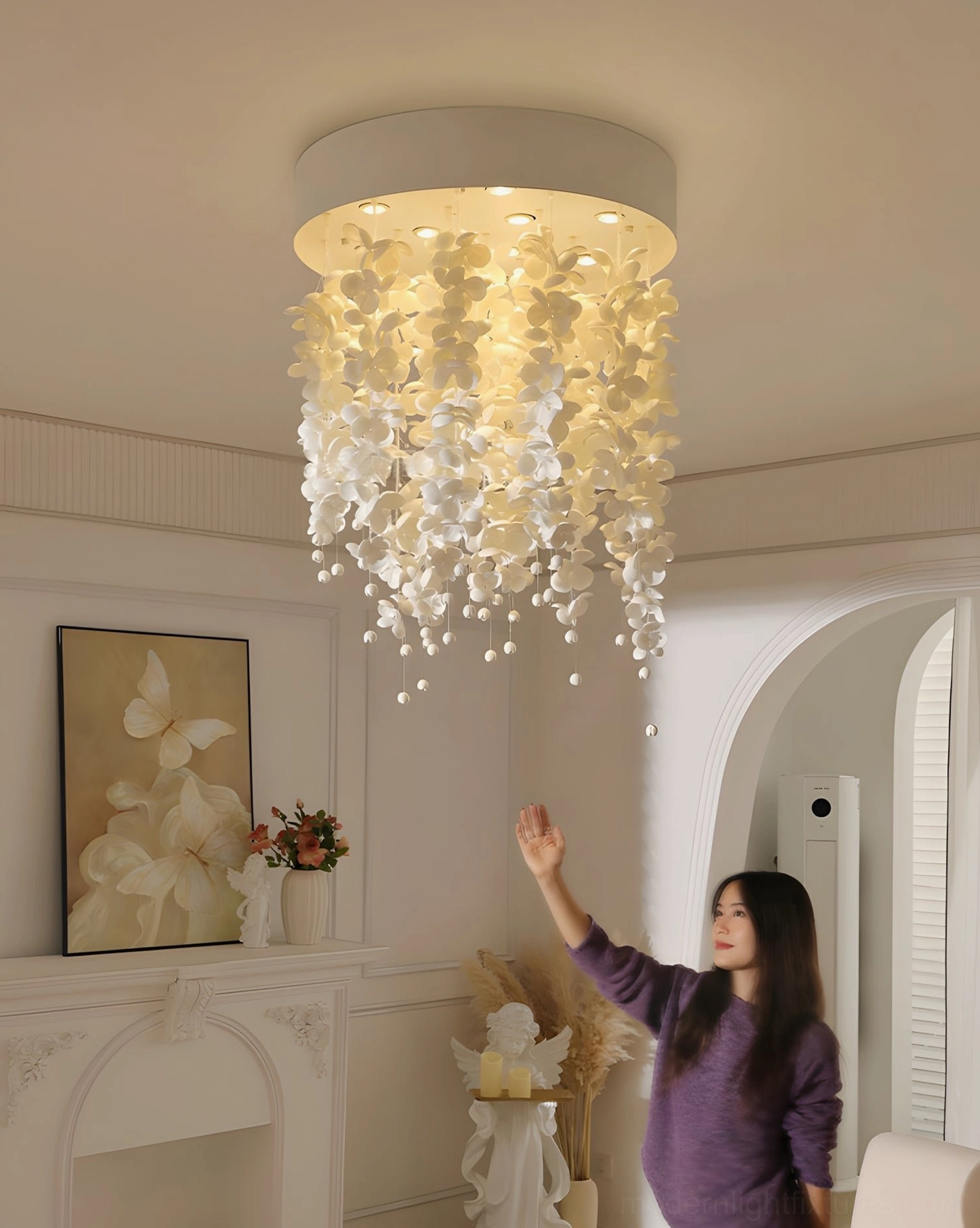 Contemporary ceramic flower chandelier with warm ambient illumination in elegant dining room with fireplace