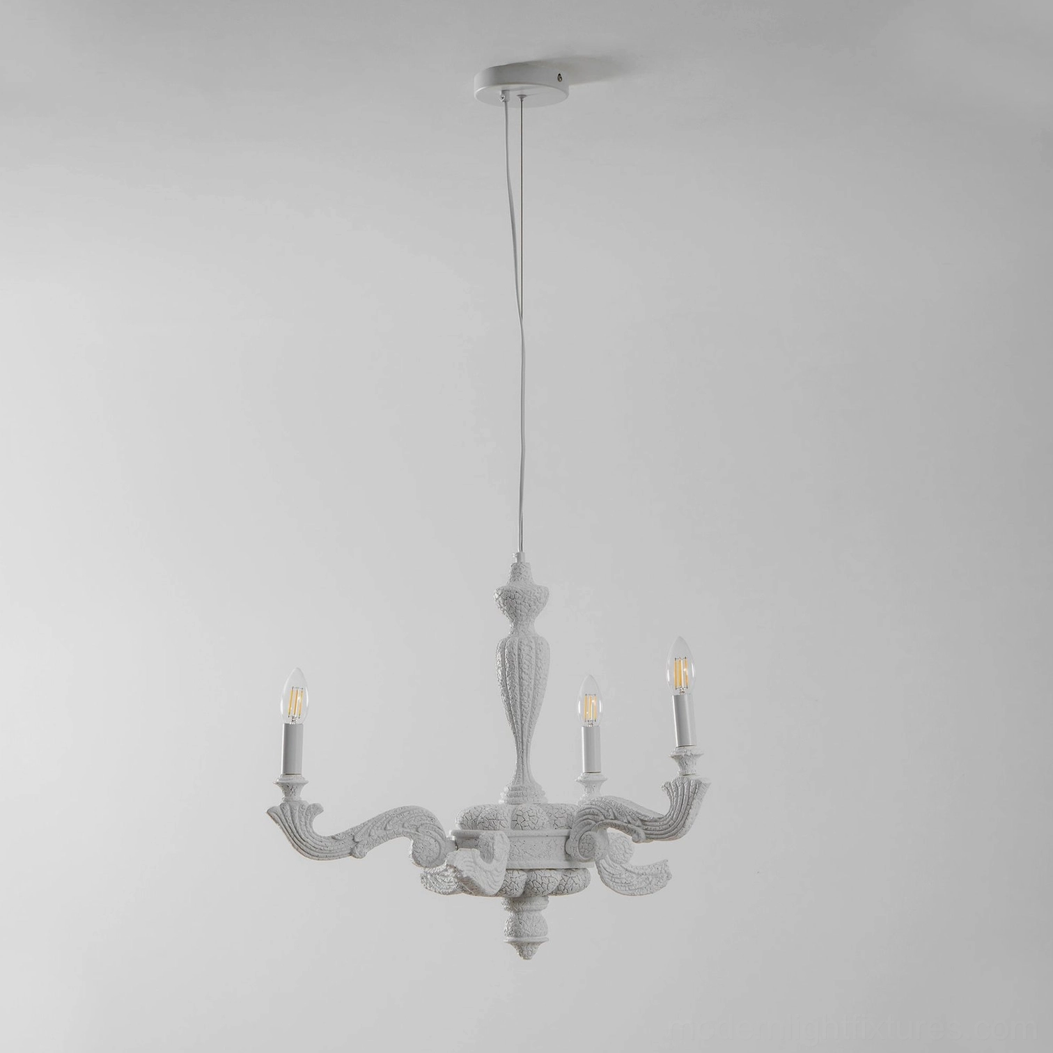 Close-up detail of Lvoria chandelier showing carved detailing, tapered arms, and E14 sockets