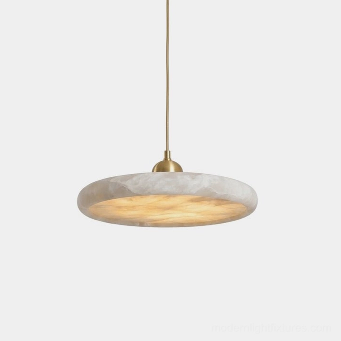 Lydia alabaster pendant lamp close-up showing warm brass cap, natural stone disc with organic veining, and integrated LED backlit glow