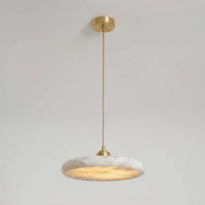 Lydia alabaster pendant lamp overhead view highlighting slim brass suspension rod, minimalist flat disc design, and low 3.7 inch profile