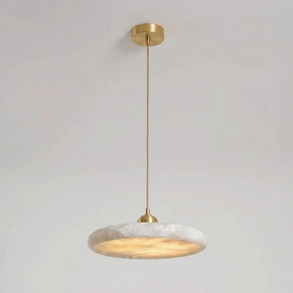 Lydia alabaster pendant lamp overhead view highlighting slim brass suspension rod, minimalist flat disc design, and low 3.7 inch profile