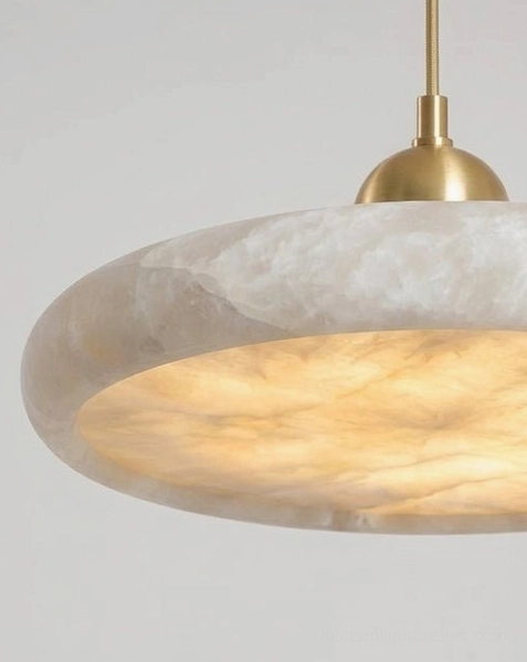 Lydia alabaster disc pendant lamp detail view showing natural stone texture, organic veining, warm brass mounting hardware