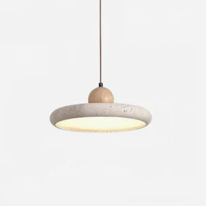 Lydia modern pendant lamp overhead angle displaying round travertine shade, smooth wood top cap, and diffused warm ambient lighting