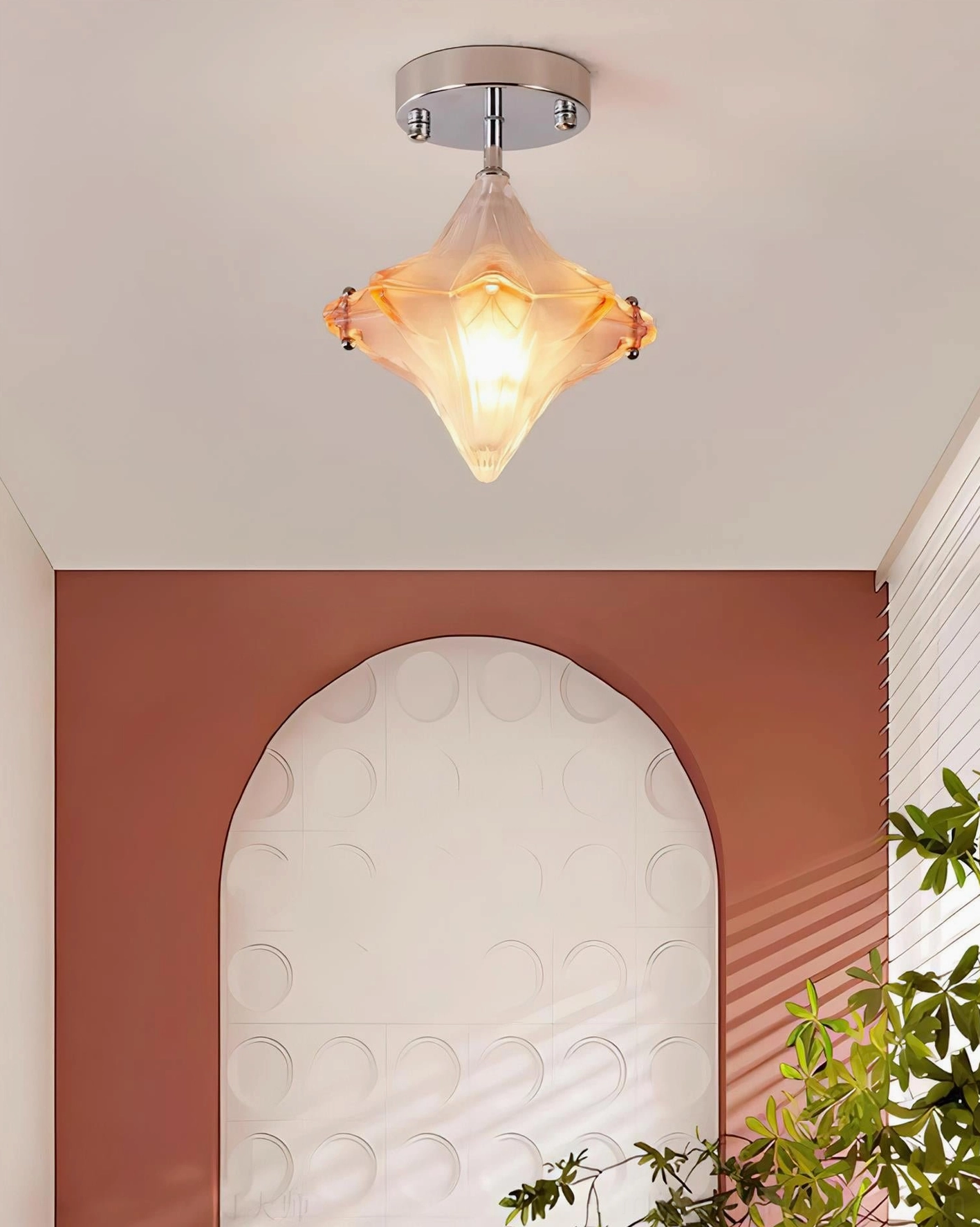 Lyra star ceiling light fixture installed in modern residential entryway with terracotta accent wall, low-angle overhead view