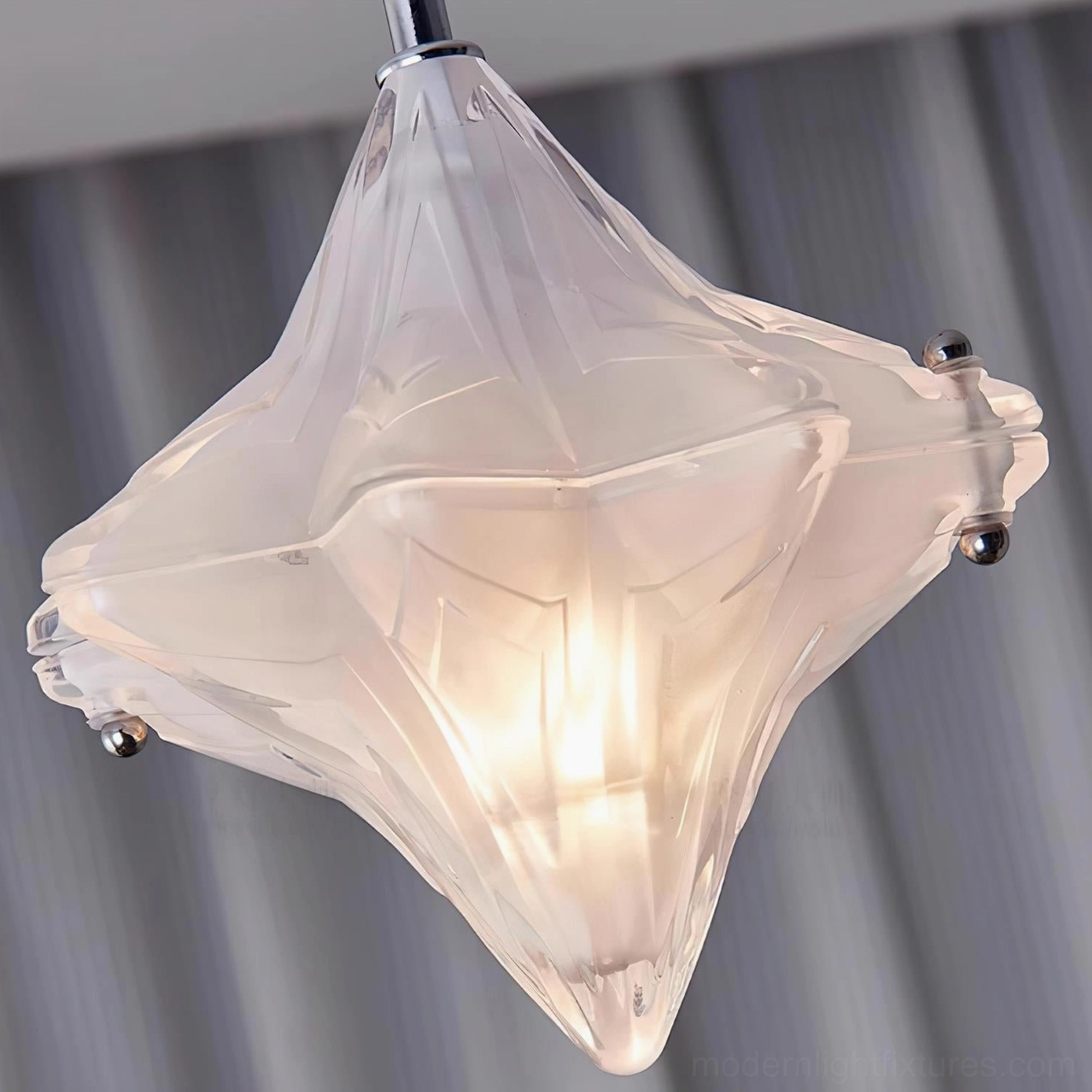 Lyra diamond star ceiling lamp showing faceted frosted glass geometry and illuminated center bulb, side angle view