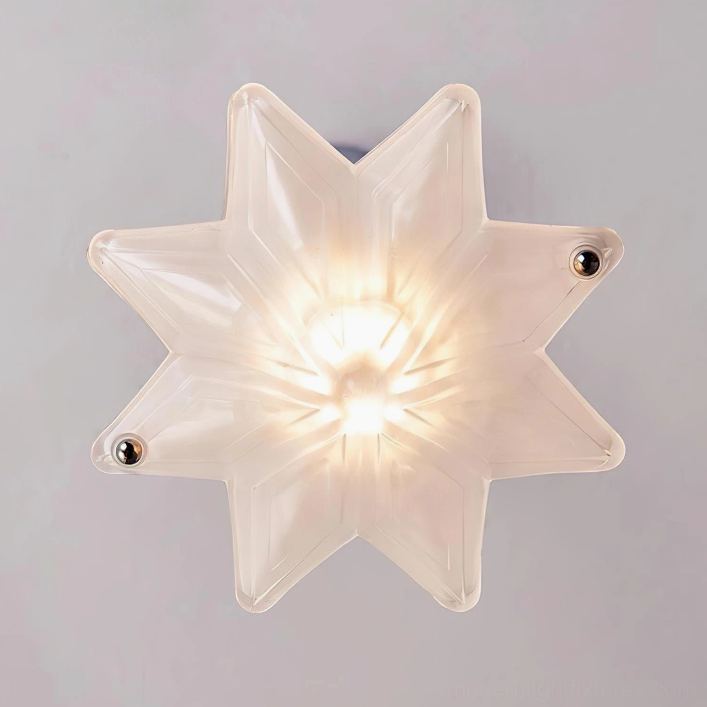Lyra eight-pointed star flush ceiling lamp with clear frosted white glass and chrome mounting, illuminated close-up view