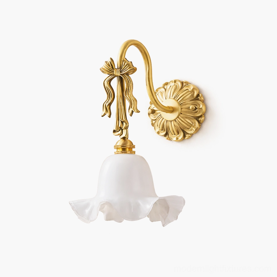 Lysette brass wall sconce with bow ornament detail and ruffled white glass shade, studio product shot