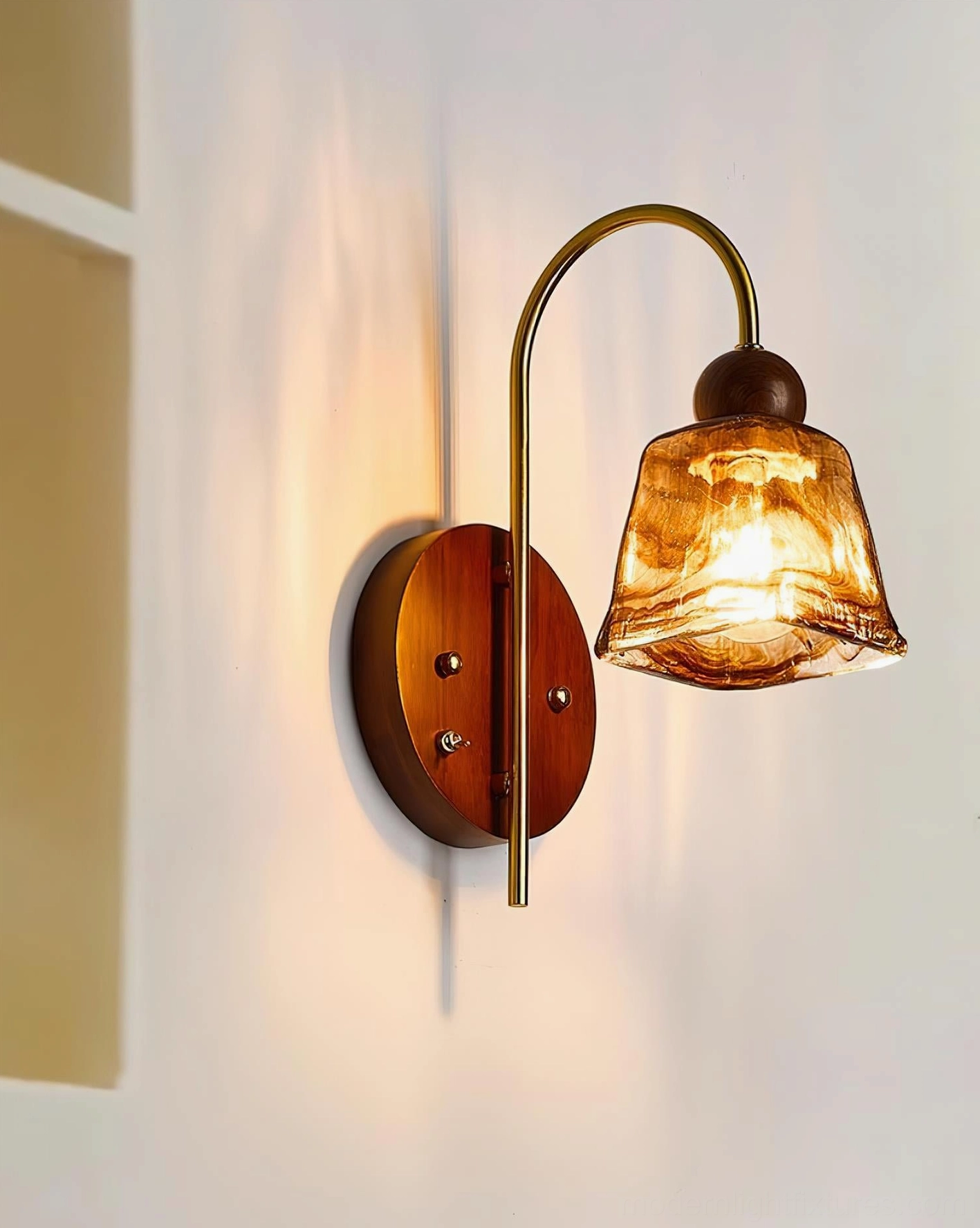 Lysora wall sconce side angle, marbled amber glass shade, brass arm, walnut wood base detail