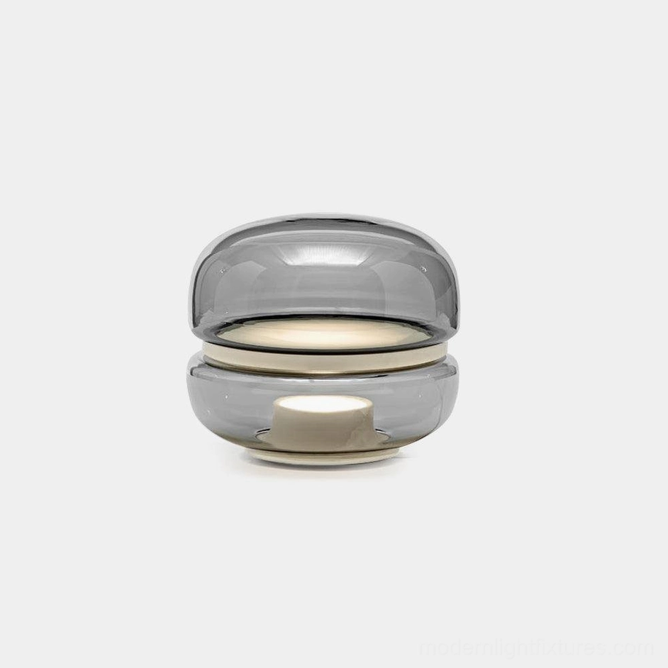 Macaron stone glass table lamp front view with handblown glass dome and integrated LED warm light on white studio background