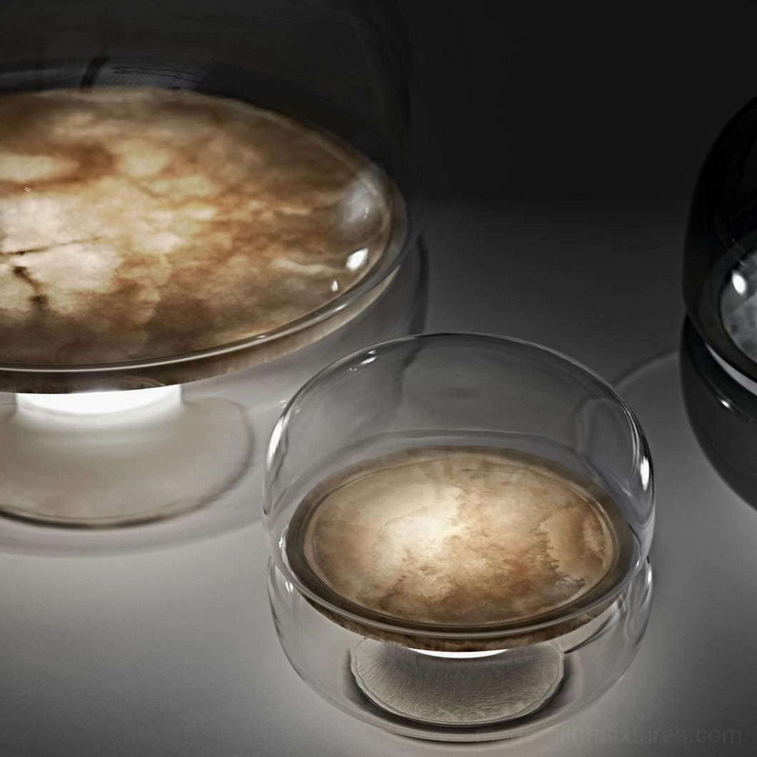 Close-up low angle detail of Macaron alabaster table lamp showing clear glass outer shade and amber marble-style stone diffuser