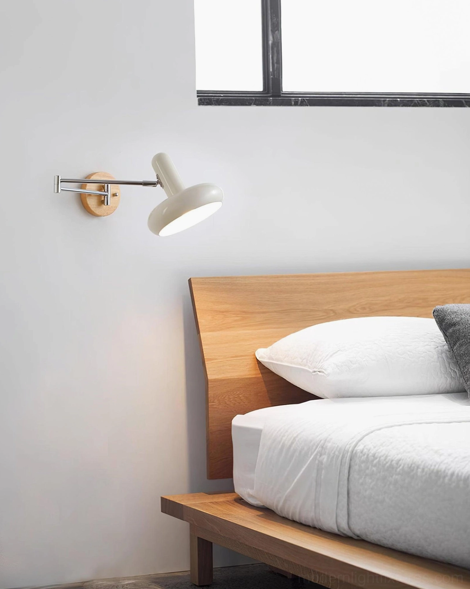 Maddie modern wall sconce with adjustable arm mechanism showing full range of articulation and positioning capability