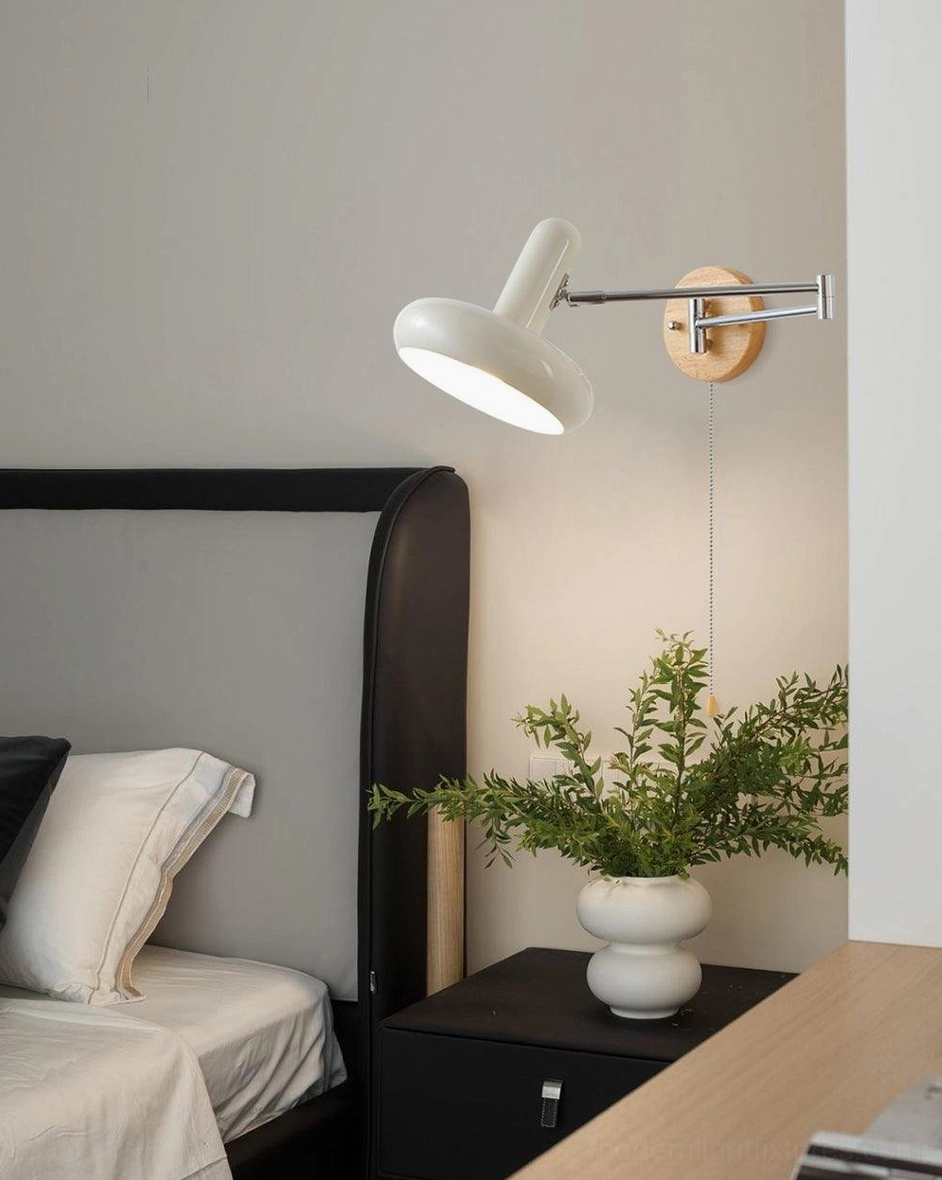 Maddie wall sconce detail shot highlighting chrome metal arm and milk-white trumpet shade design elements