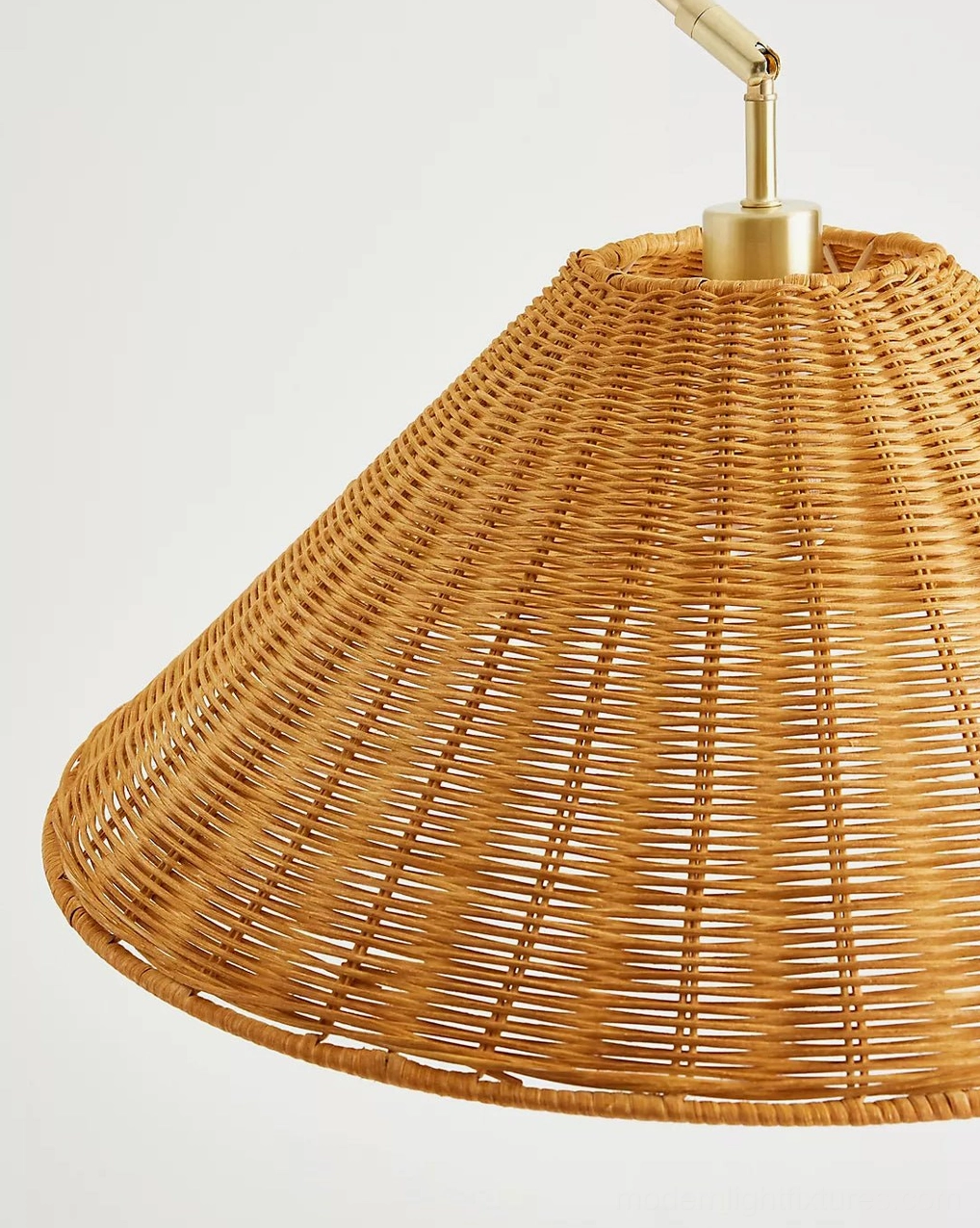 Madera arc floor lamp detail shot showing fine hand-woven natural rattan texture and warm metallic stem finish